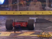 A struggling FlatBot gets charged by Toe Crusher.