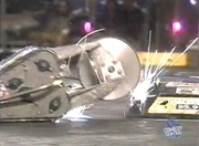 American Justice gets hit by Atomic Wedgie's spinning disc.
