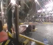 Atomic Wedgie gets slammed against the arena wall by Maximus.