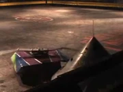 Botknocker-19 is pinned against the wall.