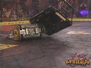 Atomic Wedgie runs under and almost flips Minion.