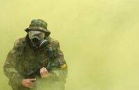 A US Navy Sailor wearing a gas mask.