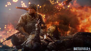Pac kneeling beside Dunn as his leg is trapped under rubble. Notice that Dunn has a Blackbeard Flag Patch on his shoulder.