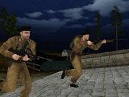 Two British Commandos cross a bridge at Kbely Airfield.