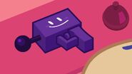 The Laser Gun shown on a red desk with Pie looking at it in The Worst Day of Black Hole’s Lige