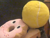 The Woody plush can be seen under a stuffed donut and a stuffed tennis ball