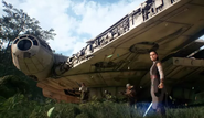 Rey next to the Millennium Falcon outside of Maz's Castle on Takodana.