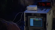 Dawn sets up a vital status monitor with six electrodes plugged in and fitted with a clock to time herself