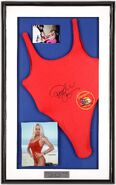 One of Pamela's swimsuits in a glass frame, signed by Pamela herself