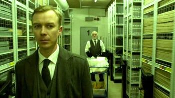 Arthur stands behind Mr. Rook