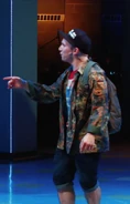 Rich in a camo jacket and hat with a backpack on