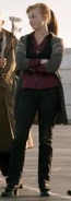 Gwen in a wooly jacket, maroon shirt, black vest, and gray jeans in Alien Swarm