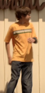 Ben in an orange T-shirt and no coat