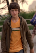 Ben in an orange T-shirt and coat