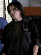 Kevin in a bluish black mechanic's jacket in Alien Swarm