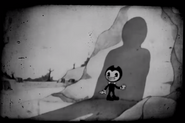 Bendy with a creepy smile while looking at the unknown person before the cartoon ends.