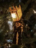 Фигурка из картона на новогодней ёлке.