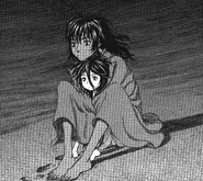 Casca sits with her arms wrapped protectively around the Moonlight Boy.