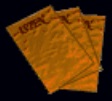 Sprite of the Play Tickets against a black background. The tickets consist of three sheets of wrinkled orange leather stacked at slight diagonals to one another. Each sheet has large red lettering at its top. The lettering on the uppermost sheet reads "Isten" in uppercase letters