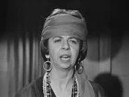 Gladys summons the dead.