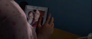 Jodie holding a photo of Zoey and Tuesday