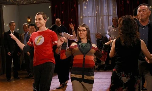 Sheldon and a drunken Amy dancing together.