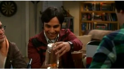 Raj looking at a goldfish jar.