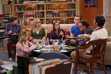 The gang having dinner, not takeout, around the living room coffee table.