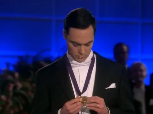 Sheldon examining his medal.