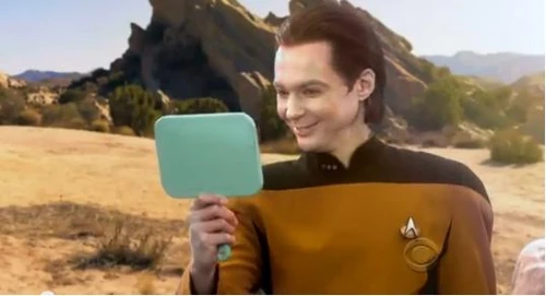 Sheldon admiring his makeup.