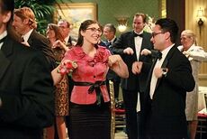 Amy and Leonard dancing the Chicken Dance at a wedding.