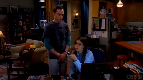 Amy typing up Sheldon's tunnel log.