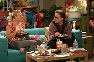 Sharing a meal at Penny's apartment. Penny is distracted.