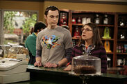 Sheldon buys Amy a beverage.