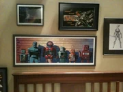 Framed superhero pictures above the bed.