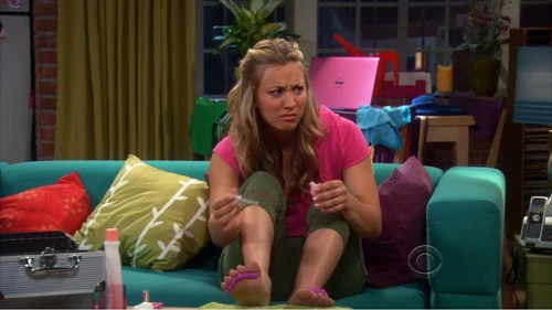 Penny listening to Sheldon and Leonard argue.