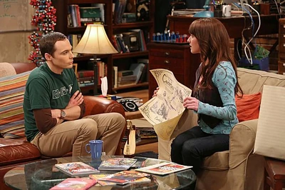 Alex showing Sheldon the Valentine's Day gifts she bought for him for Amy.
