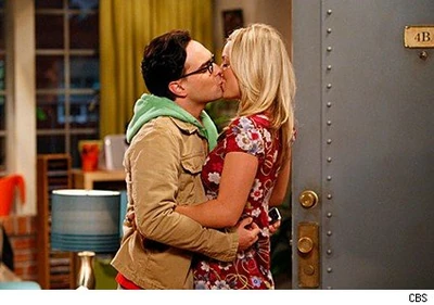 Kissing each other.