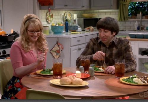 Laughing at Raj's ideas.