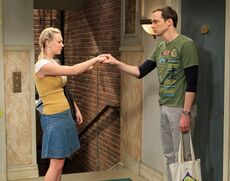 Penny and Sheldon in hallway.