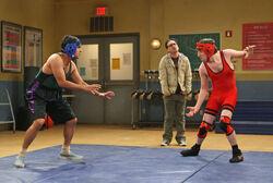 Howard and Raj wrestle while Leonard watches