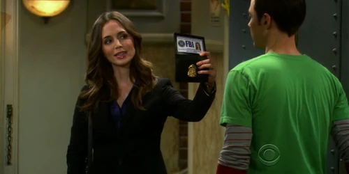 Showing Sheldon her badge.