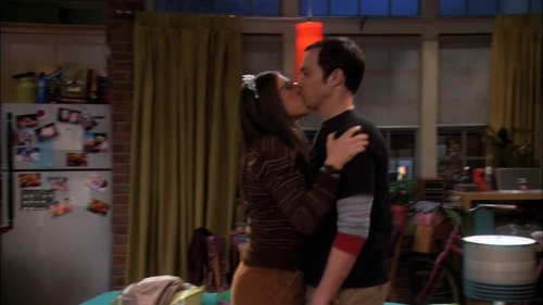 Amy kisses Sheldon to thank him for the tiara.