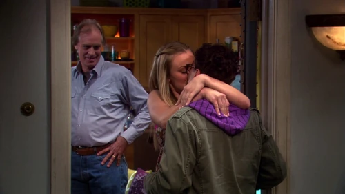 Penny kissing Leonard for her father's sake.