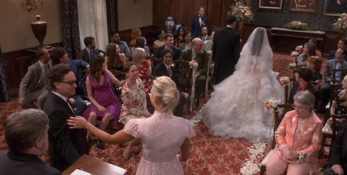Penny and Leonard following down the aisle.