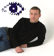 Dermot's Big Brother 6 publicity photo with the blue and black logo above his left