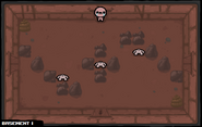 Three Hoppers, each next to an assortment of rocks, with two piles of poop in opposing corners of the room.