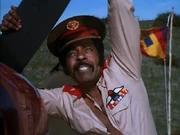 Captain Braco.  Note the flag of Mgunda in the background.