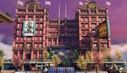 A large apartment building. Note the American flags on the roof and the style of the building is similar to what was common in New York City at the time.