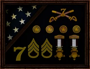A shadowbox in Booker's office, featuring his 7th Calvary memorabilia, U.S. Army rank insignia, medals, and a folded American flag.